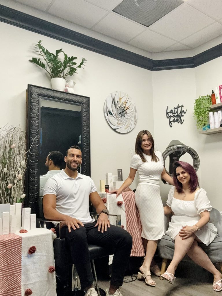 A group of LUX Salon Suites pros and friends gathered inside a suite