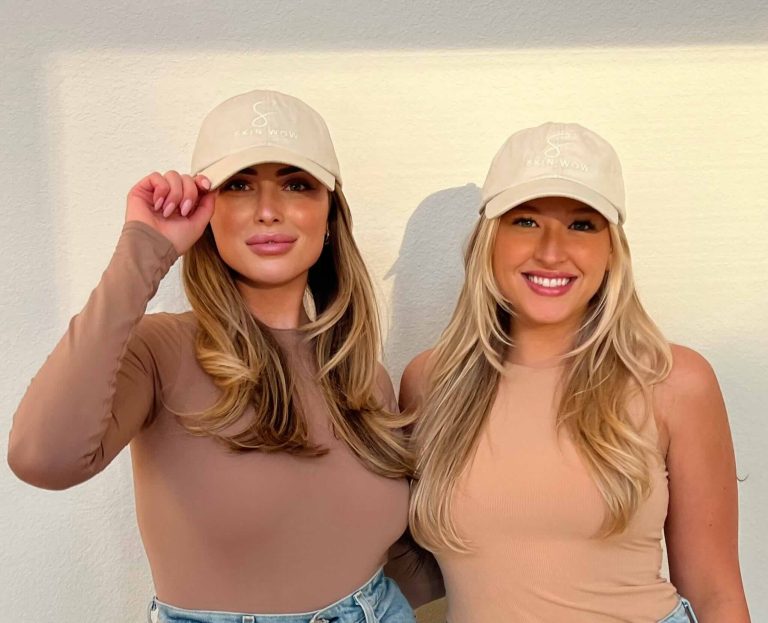 Two LUX Salon Suites pros smiling together in matching caps